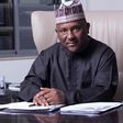 Abdulsamad Rabiu, the second-richest man in Africa and BUA Group Chairman, seated at his desk in a professional office setting.