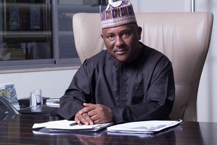 Abdulsamad Rabiu, the second-richest man in Africa and BUA Group Chairman, seated at his desk in a professional office setting.