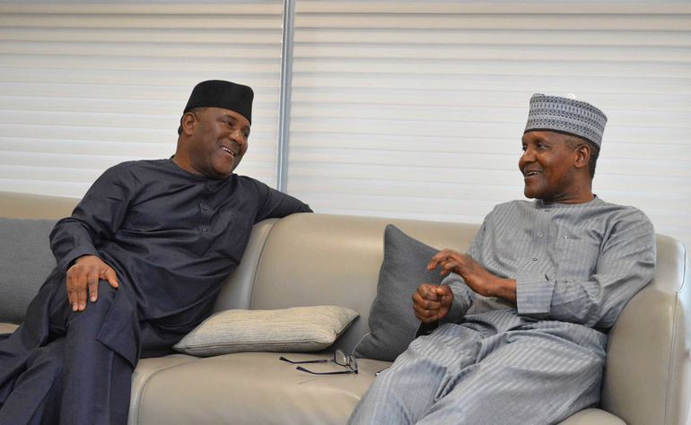 BUA Group Chairman Abdulsamad Rabiu and Aliko Dangote sharing a candid conversation on a sofa, representing Nigeria's top two billionaires.