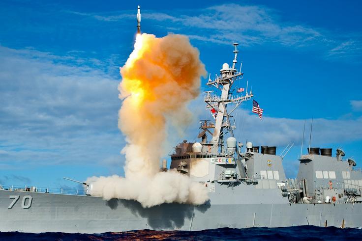 An Arleigh Burke-class guided-missile destroyer, like the USS Mason, launching a vertical interceptor missile from its deck during a naval engagement.