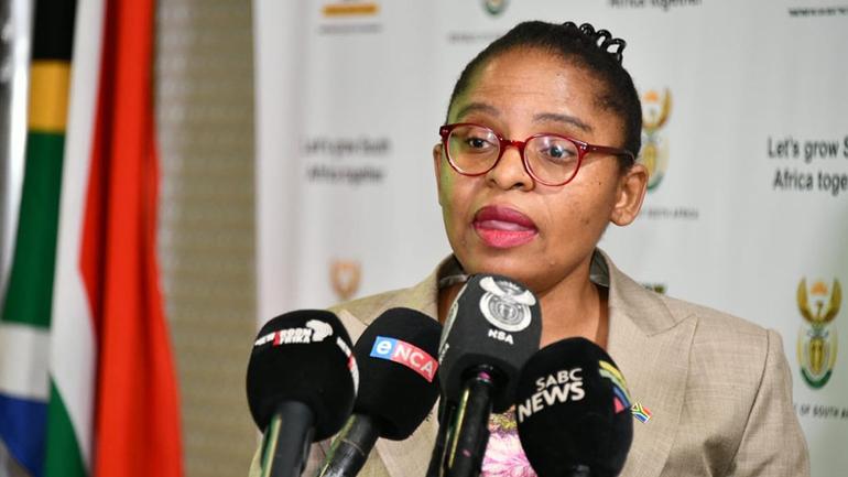 South African Minister Khumbudzo Ntshavheni speaking to journalists at a press conference.