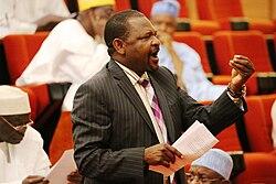 Senator Abdul Ningi standing and speaking passionately during a Nigerian Senate debate.