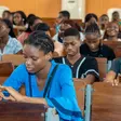 Nigerian university students in a lecture hall focusing on theoretical coursework.