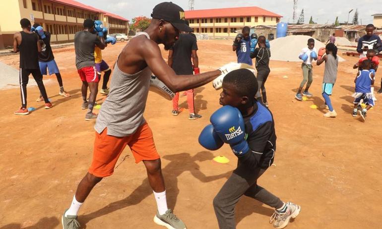 Young Nigerians training in an outdoor boxing gym to build discipline and alternative skills.