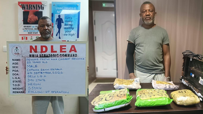 Suspected drug kingpin Festus Ibewuike in NDLEA custody, photographed holding an identification placard detailing his arrest in Cotonou and standing beside seized parcels.