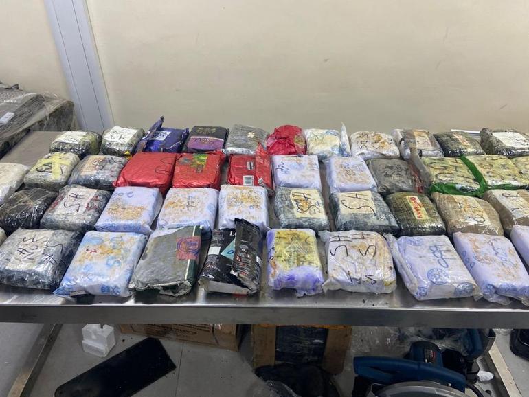 A wider view of the massive haul of individually wrapped drug packages seized by authorities.