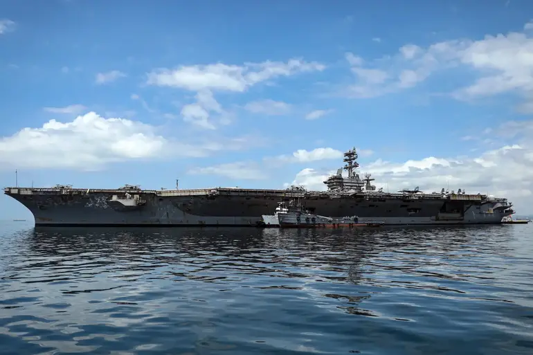 US Navy aircraft carrier deployed near the Strait of Hormuz amid escalating US Iran military tensions.