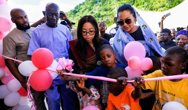 Nadia Zakaria cuts the ceremonial ribbon alongside local children and community leaders to officially open the facility.