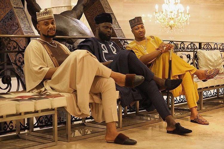 Alexx Ekubo, IK Ogbonna, and Yomi Casual sitting together in traditional Nigerian attire, representing the 'Chop Life Gang.'