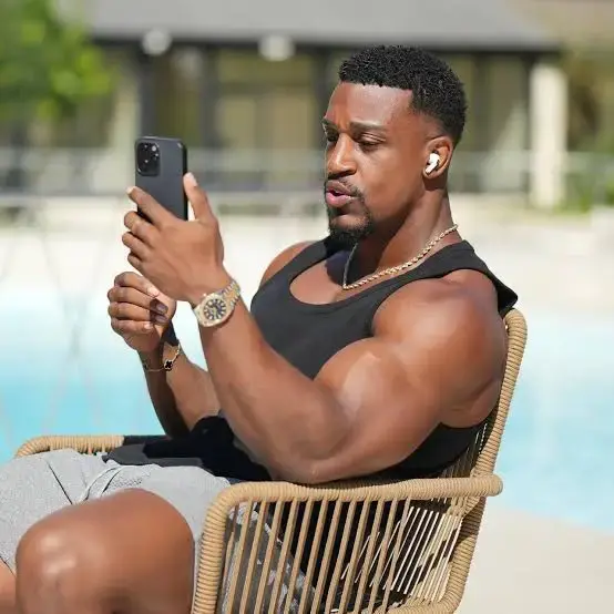 Fitness influencer Ashton Hall relaxing poolside, documenting his travels in Nigeria after touring six African countries.