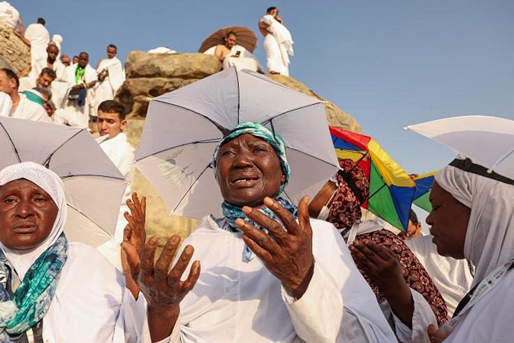 Nigerian Muslim pilgrims praying on Mount Arafat during Hajj pilgrimage in Saudi Arabia.