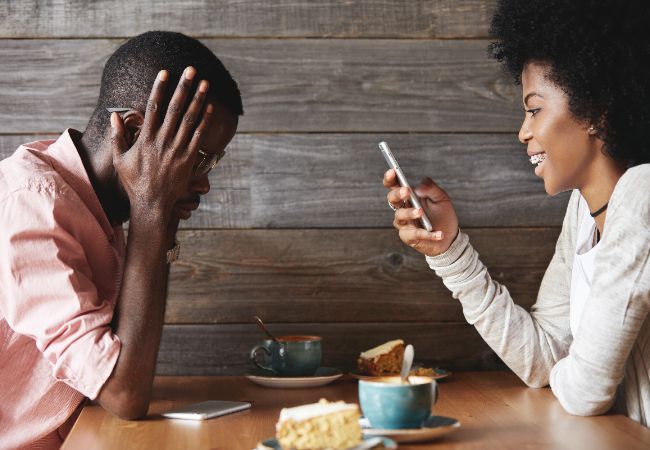 Young man and woman sitting in cafe