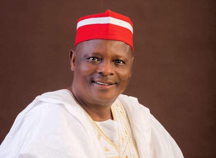 Senator Rabiu Musa Kwankwaso of Nigeria wearing his distinct red cap with white stripe and traditional white traditional 'agbada' clothing.