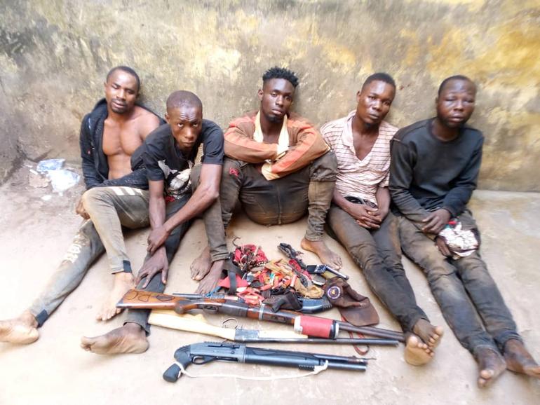 A picture of arrested kidnappers in Edo (a pump-action shotgun, ammunition, and more were recovered from the suspects)
