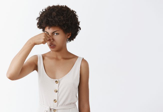 Woman holding her nose