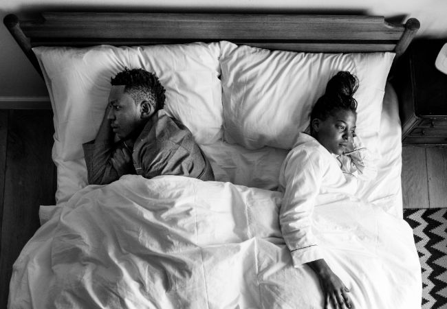 Couple sleeping back to back