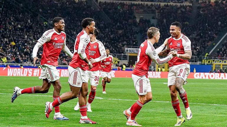 Gabriel Jesus (wearing jersey number 9), Martin Ødegaard, William Saliba and Ethan Nwaneri, alongside other players, all ecstatic and dressed in Arsenal’s iconic red and white home kits with red socks.