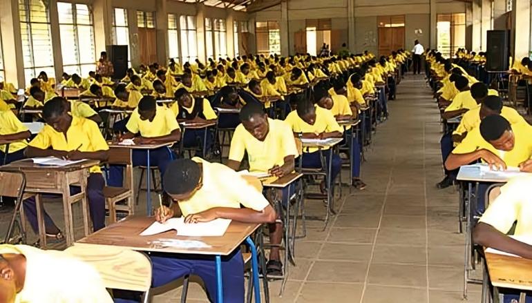 Students meticulously writing their tests during an examination session.