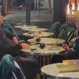 Couple continue romantic date as protesters clash and fires burn near café in France