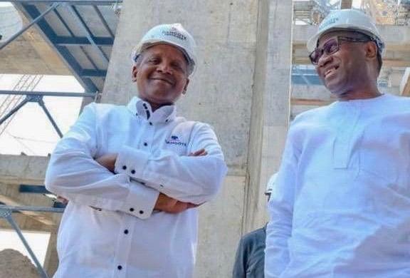 Femi Otedola and Aliko Dangote wearing hard hats during a site tour at the Dangote Refinery ahead of the September IPO.