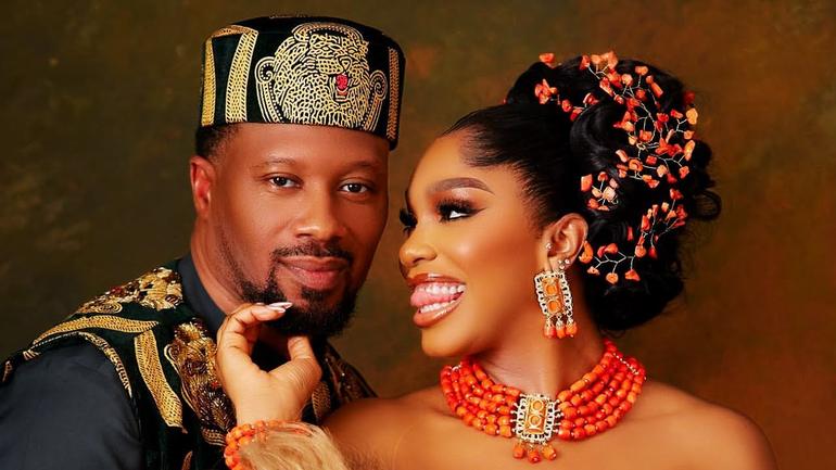 Nollywood actress Sharon Ooja and husband Ugo Nwoke in traditional Igbo wedding attire, smiling together.