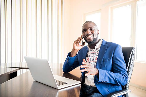 Young Nigerian professional on his phone after being able to borrow airtime