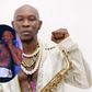 A collage featuring a portrait of Seun Kuti holding a saxophone with a circular inset of him sitting on a blue sofa during the Selahmeditate podcast interview.