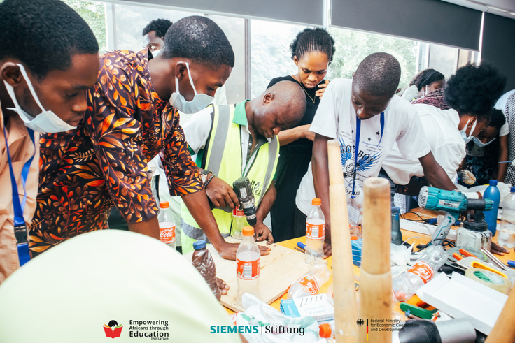 Nigerian youth getting practical vocational skills and engineering training using power tools during a BeMINT workshop.
