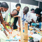 Nigerian youth getting practical vocational skills and engineering training using power tools during a BeMINT workshop.