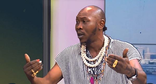 A close-up shot of Nigerian Afrobeat musician Seun Kuti speaking passionately.