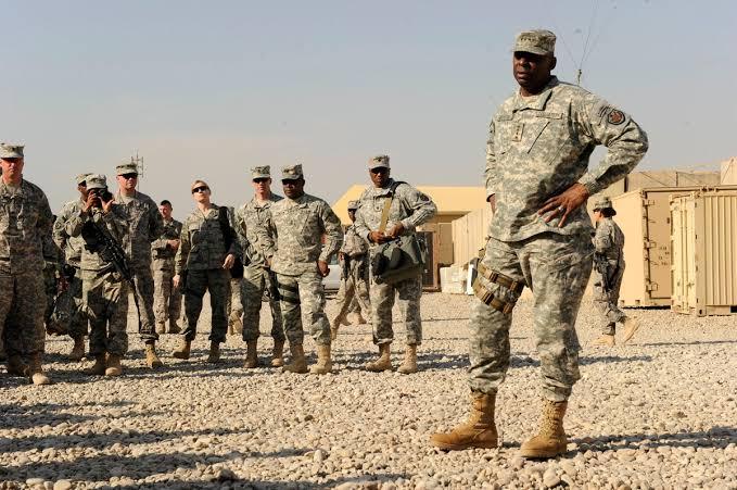 A senior officer briefs personnel at an active military deployment location.