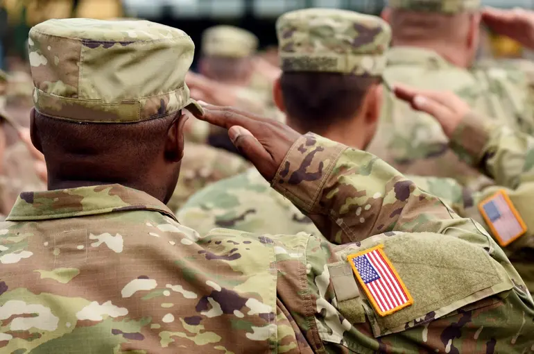 U.S. Army service members offering a formal salute during an official military event.