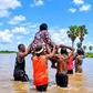 Men carry women on their heads to cross flooded road in Taraba two years after governor promised to fix it during campaign