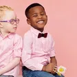 Fraternal twins with different skin tones; one child is Black and the other has albinism, illustrating genetic diversity and the possibility of different fathers.