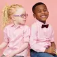 Fraternal twins with different skin tones; one child is Black and the other has albinism, illustrating genetic diversity and the possibility of different fathers.