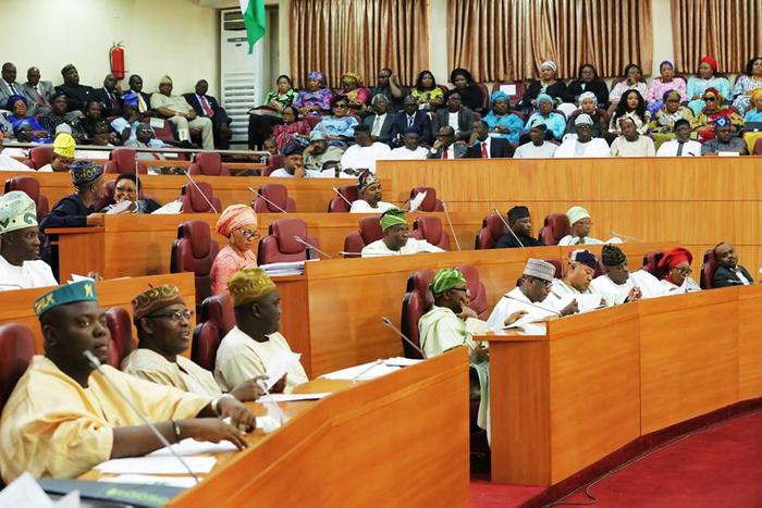 Lagos State House of Assembly lawmakers seated during a legislative session debating new tenancy and estate agent regulations.