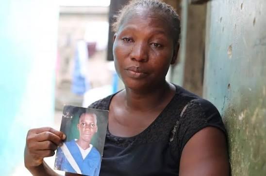 Mrs Adebose Onifade holding a picture of her late son, Pelumi, during her painful six-year battle to have the state release his remains.