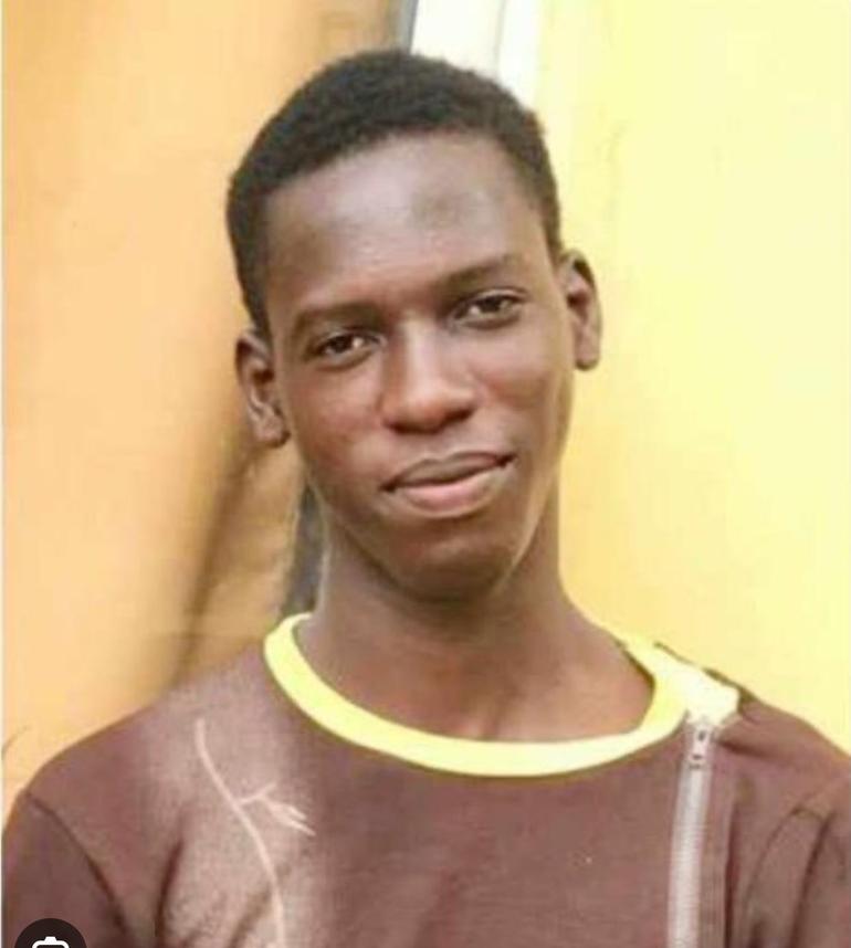 Missing Gboah TV reporter Pelumi Emmanuel Onifade smiling against a yellow wall backdrop.