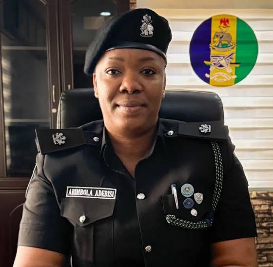 Portrait of Chief Superintendent of Police (CSP) Abimbola Adebisi wearing an official black Nigerian Police Force uniform, black beret, and name tag displaying "ABIMBOLA ADEBISI".