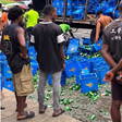 Nigerians ignore broken bottles, rush to drink spilled beer after van crashes in Lagos
