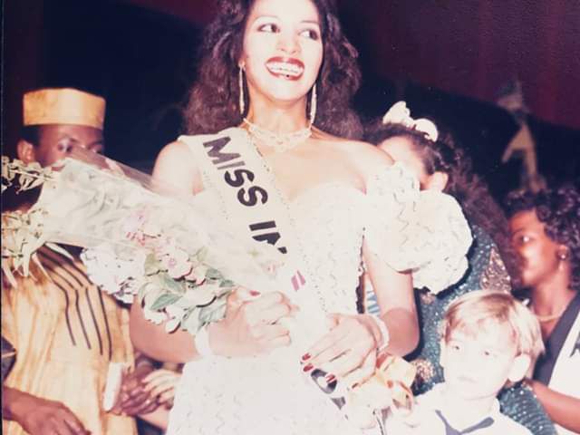 Bianca Odumegwu-Ojukwu (then Bianca Onoh) smiling as she is crowned Most Beautiful Girl in Nigeria (MBGN) 1988, holding a bouquet and wearing the "Miss Intercontinental" sash.