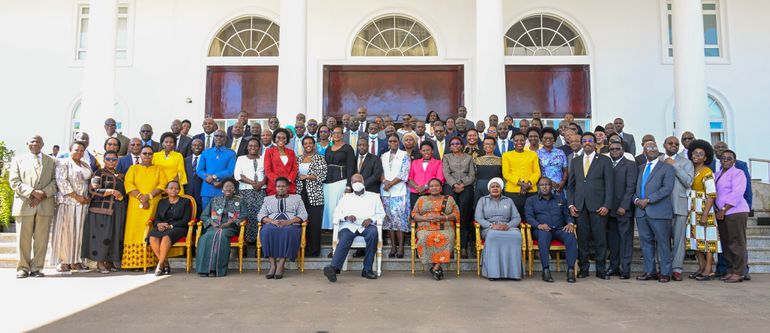 President Yoweri Museveni poses with the outgoing cabinet