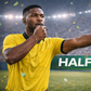 A football referee signals halftime in the match