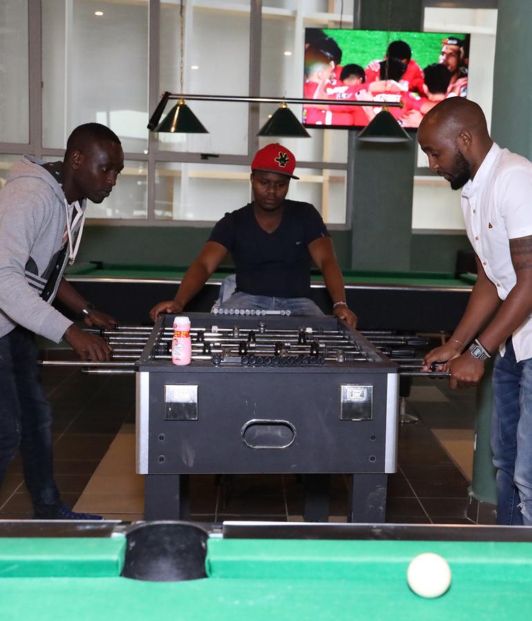Men enjoy a game of table football at an unidentified hang out spot in Nairobi CBD (Image: Files)