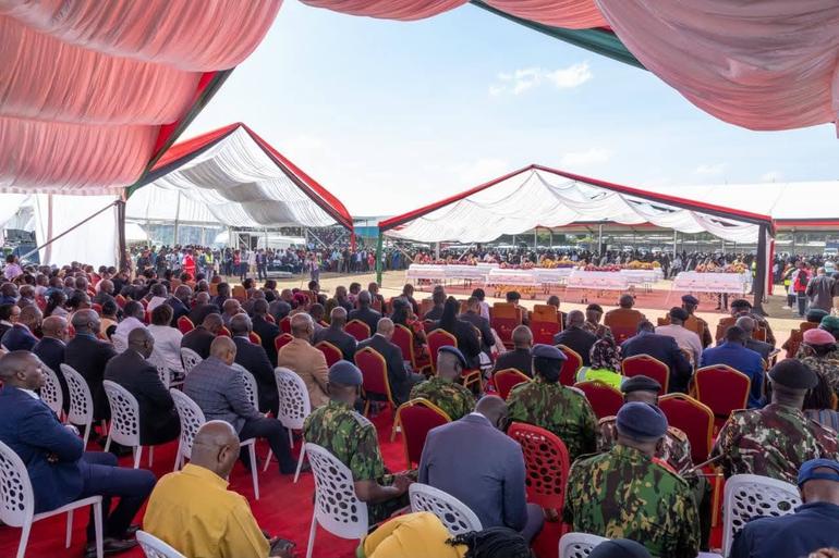 Kenyans follow proceedings at the joint requiem mass held for 15 of the 16 students from Utumishi Girls Academy at the Gilgil Stadium on June 12, 2026 (Image: Files)