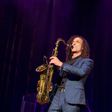 Kenny G on stage, playing the saxophone