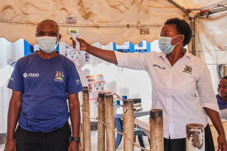 An Ugandan health practitioner demonstrates the basic test for Ebola Virus symptoms (Image: Files)