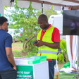 A Safaricom agent helping a subscriber. (Image: Safaricom)