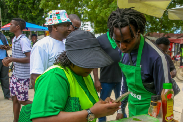A Safaricom subscriber using her phone