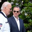 President Joe Biden, wearing a Team USA jacket and walking with his son Hunter Biden, heads toward Marine One on the South Lawn of the White House in Washington, July 26, 2024. (AP)
